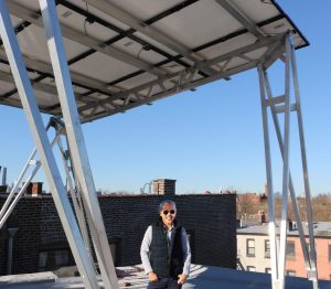 Man standing under solar canopy