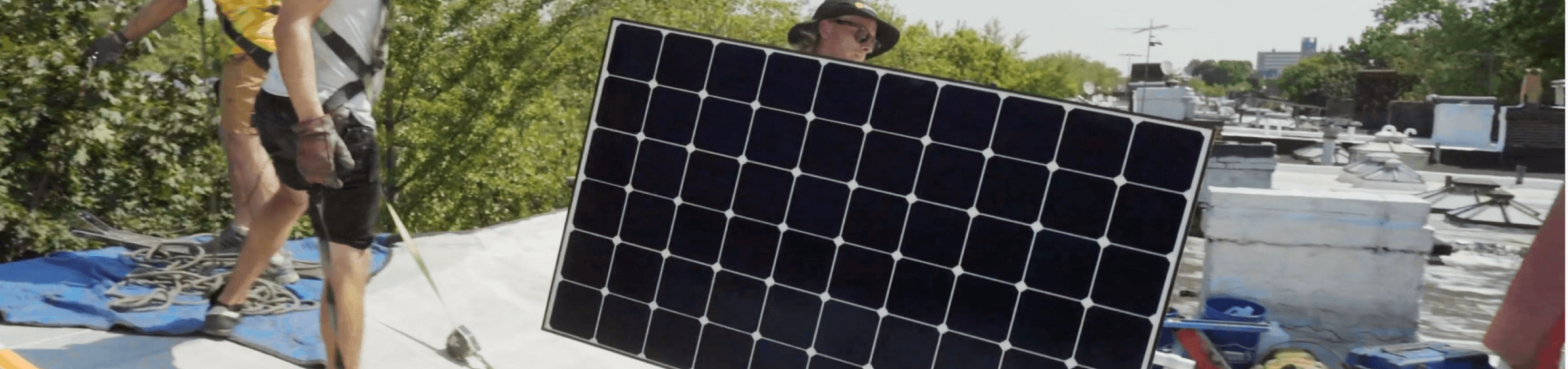 Solar installer carrying a solar panel