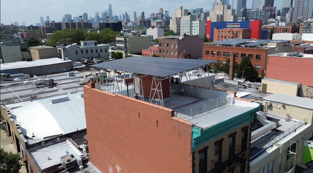 solar canopy on top of Park Slope nonprofit, CHiPS. View of Manhattan skyline in background.