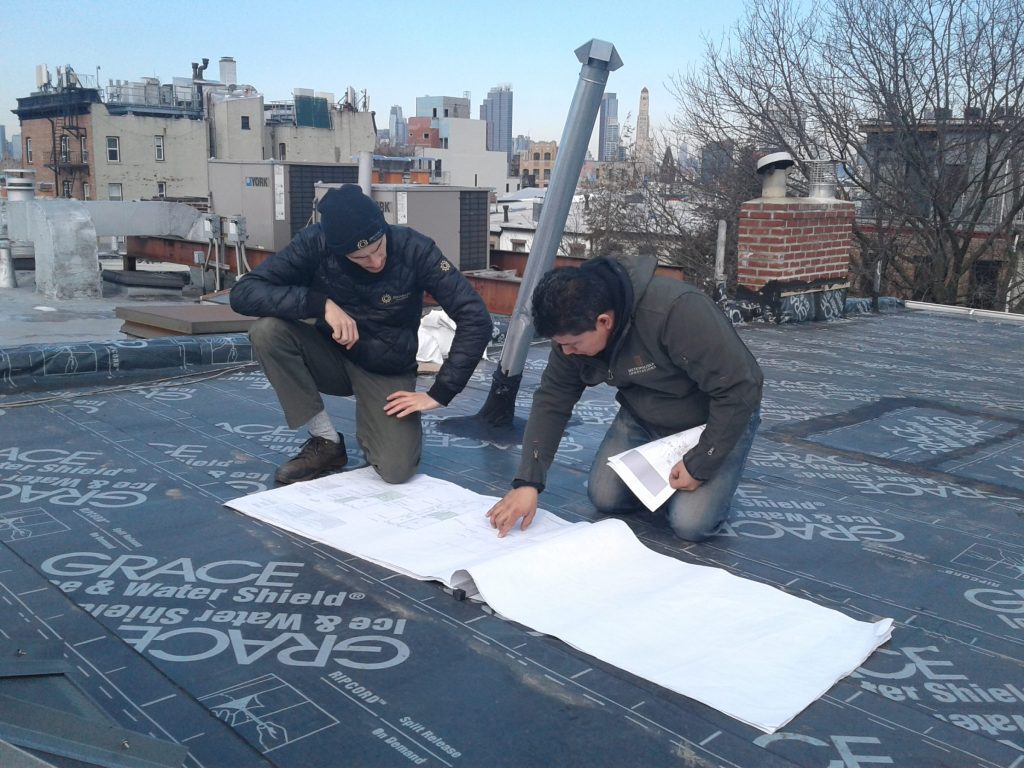 Brooklyn SolarWorks crew looking at plans on a roof