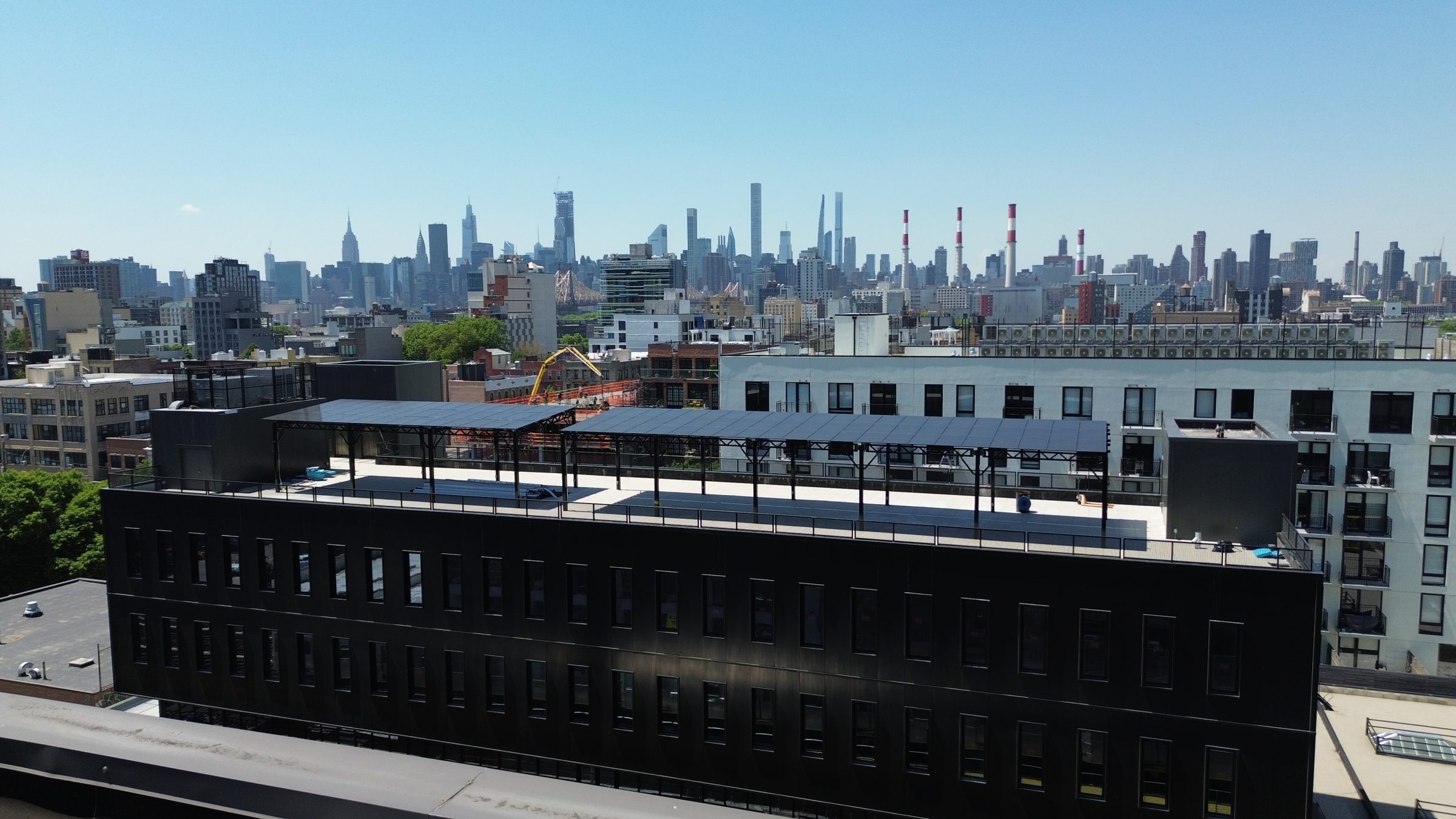A 50kW black powder-coated solar canopy system powering Ferrara Manufacturing’s newest facility in Astoria.