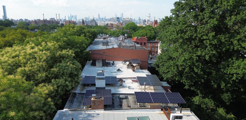 Brownstones in a Historic Tax Credit eligible area. Roofs have solar tilt racks that have limited visibility to the street.